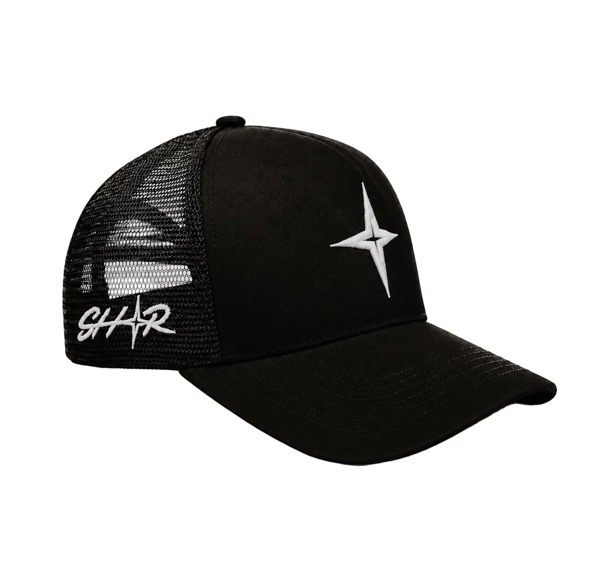 A black trucker-style baseball cap with a curved brim, black mesh back panels, a white compass star logo on the front, and a white script logo on the side, elevating outfits with minimal effort.